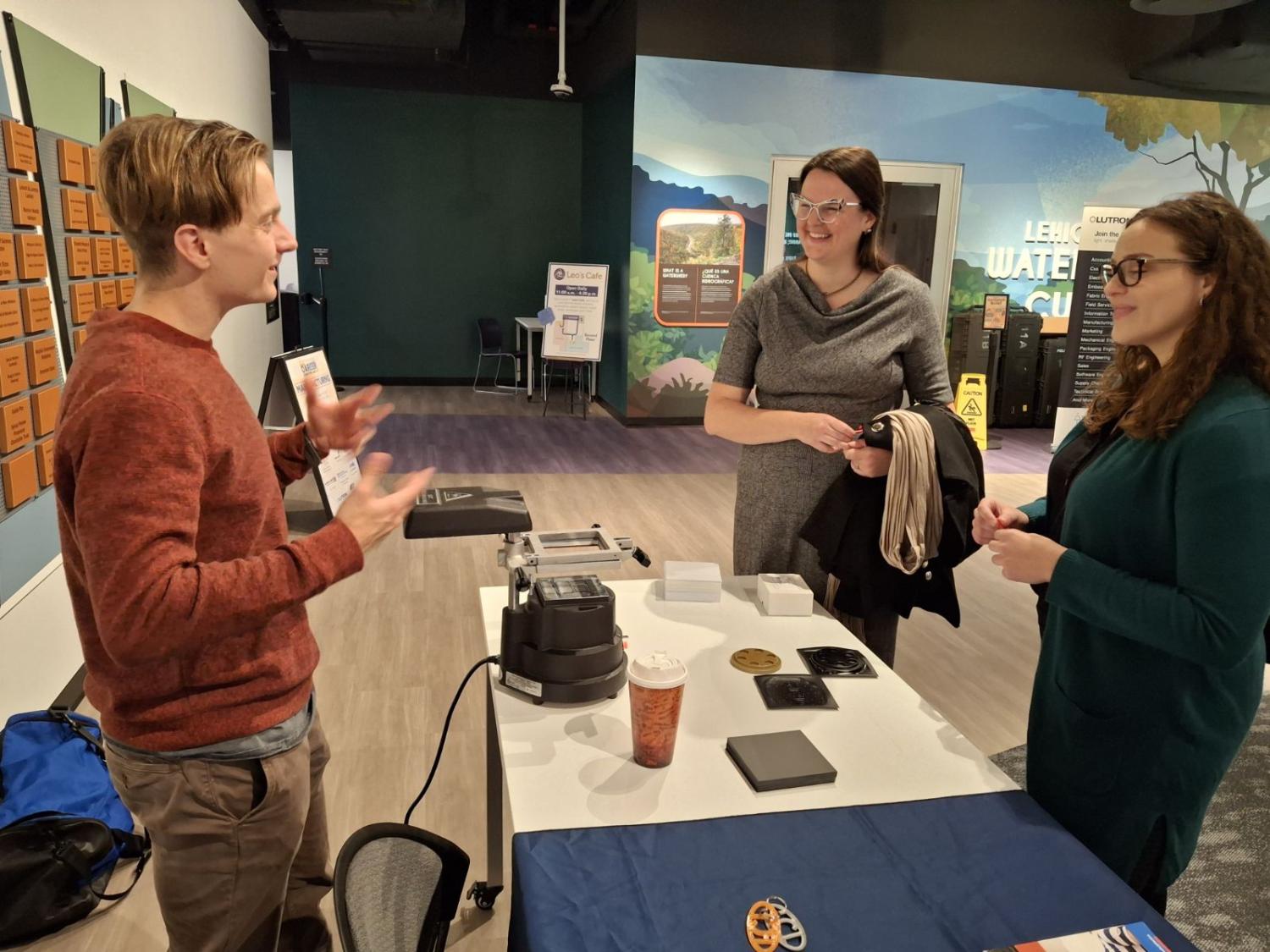 Three adults talk together