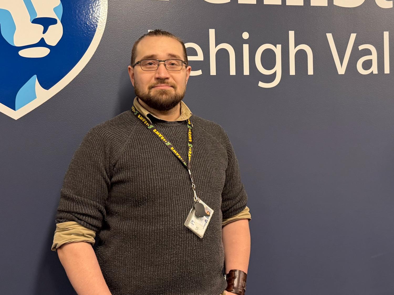 D. Edward Malinzak looking ahead while standing against the wall