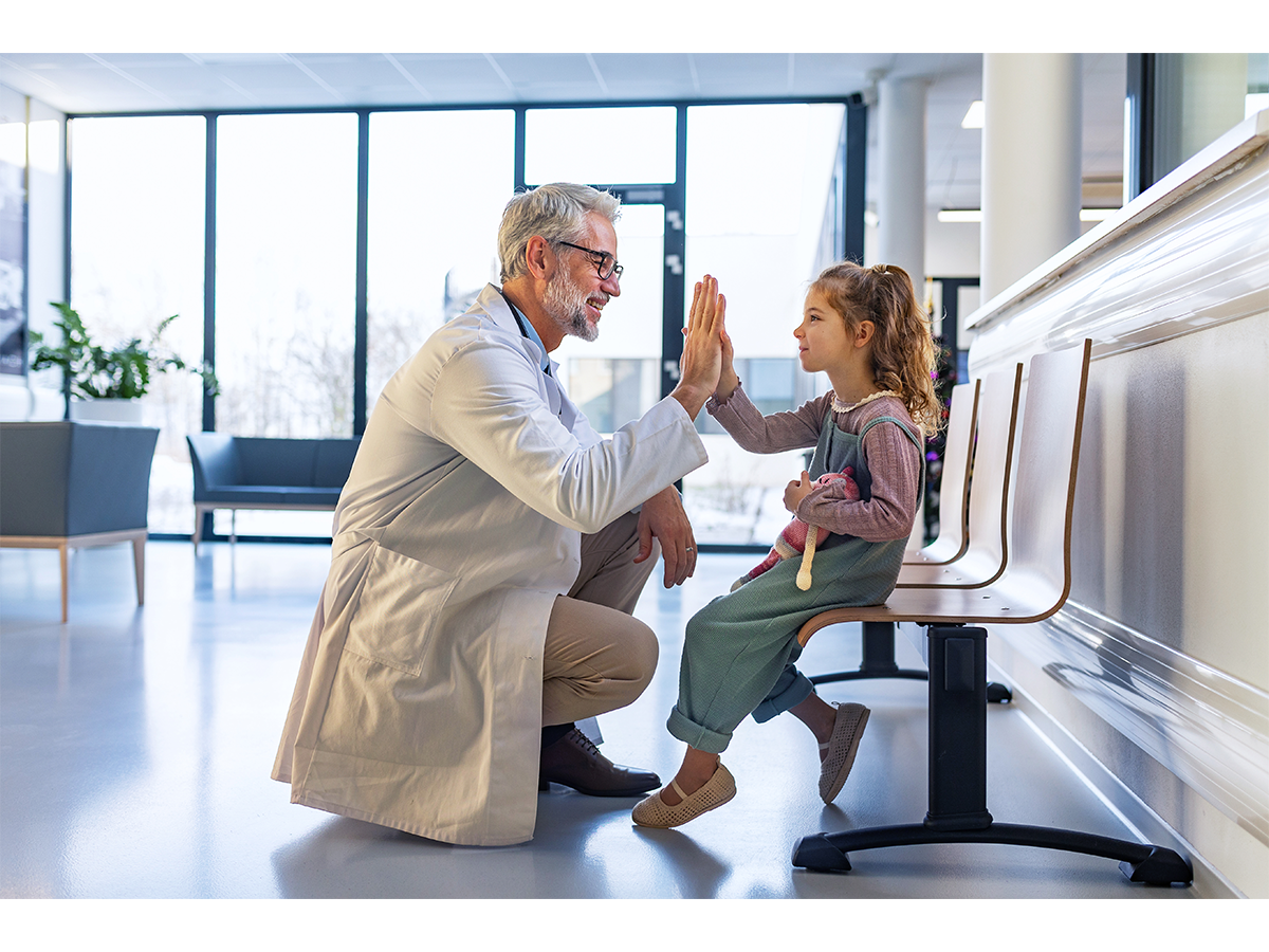 doctor giving a young girl a high five