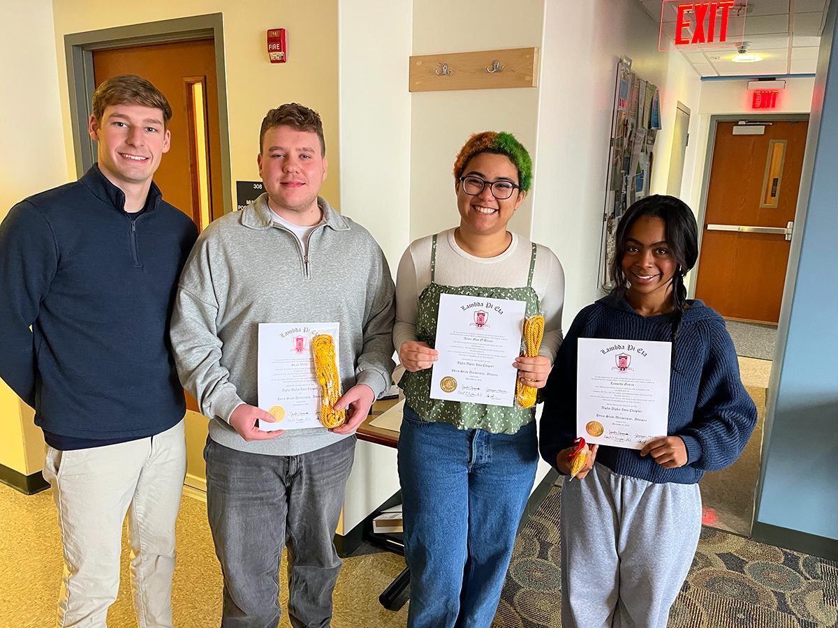 Students Adam Dotts, Sean Webb, Anna Mae O’Brien, and Lissette Green pose for a photo at the fall 2025 Lambda Pi Eta honor society induction