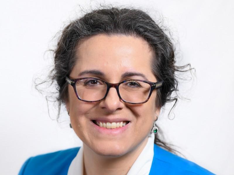 Maria Truglio wearing glasses and a blue blazer 