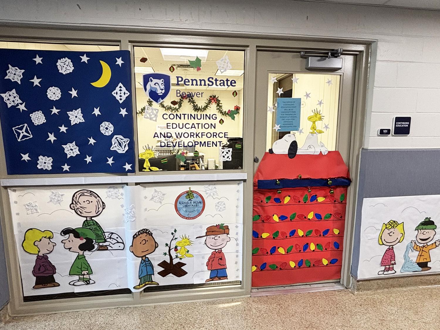 Glass door and large windows are decorated with a Peanuts theme. The door looks like Snoopy's dog house.