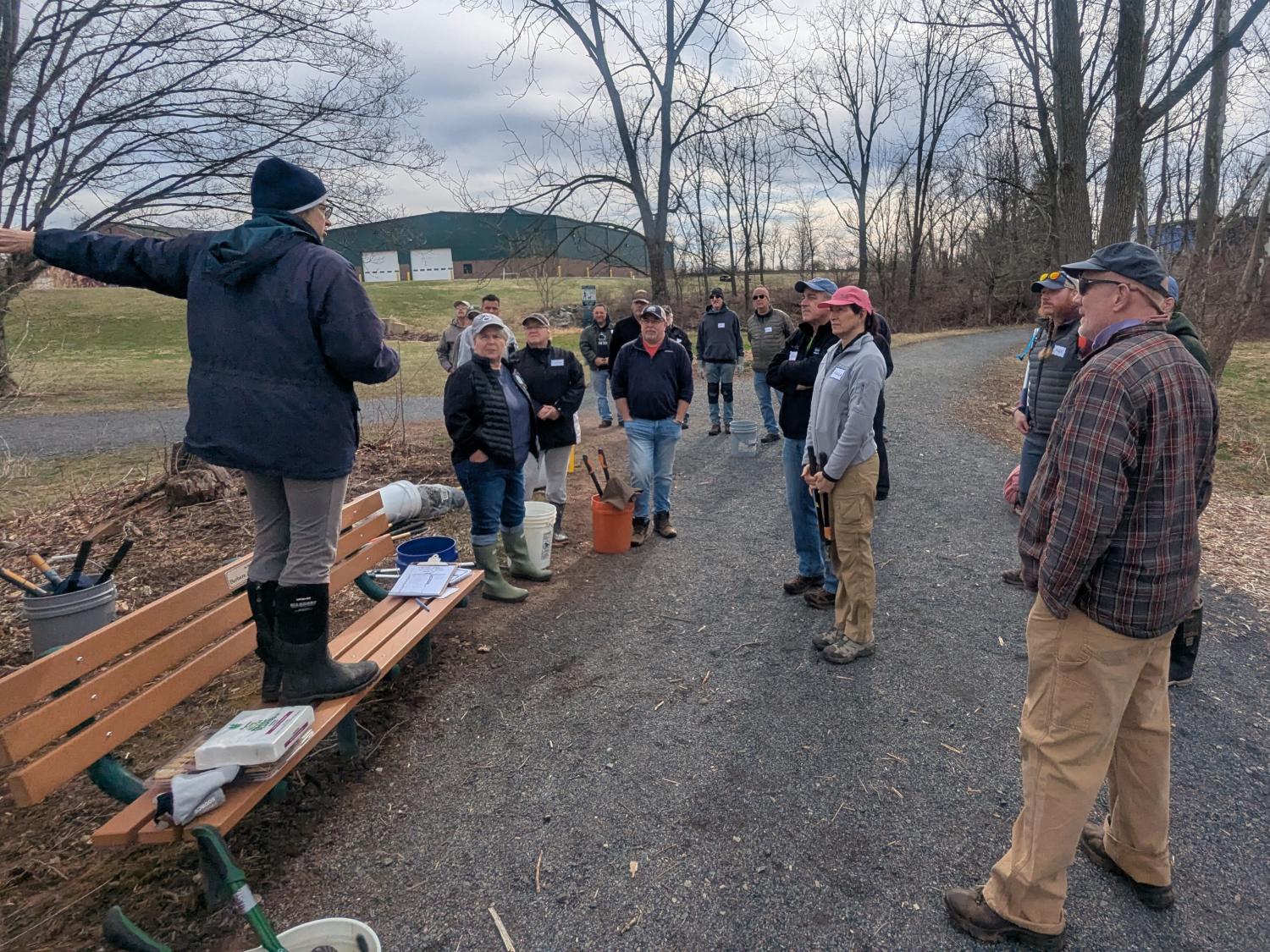 A group of people outdoors working on a public cleanup project