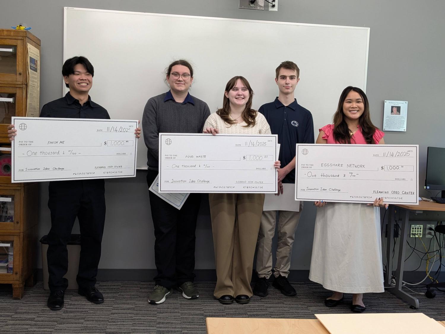 Student winners of the challenge are pictured with their big checks.