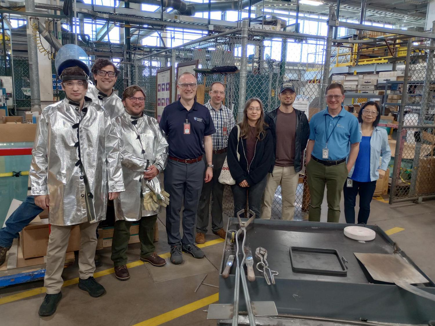 A group of people in a glass-making factory