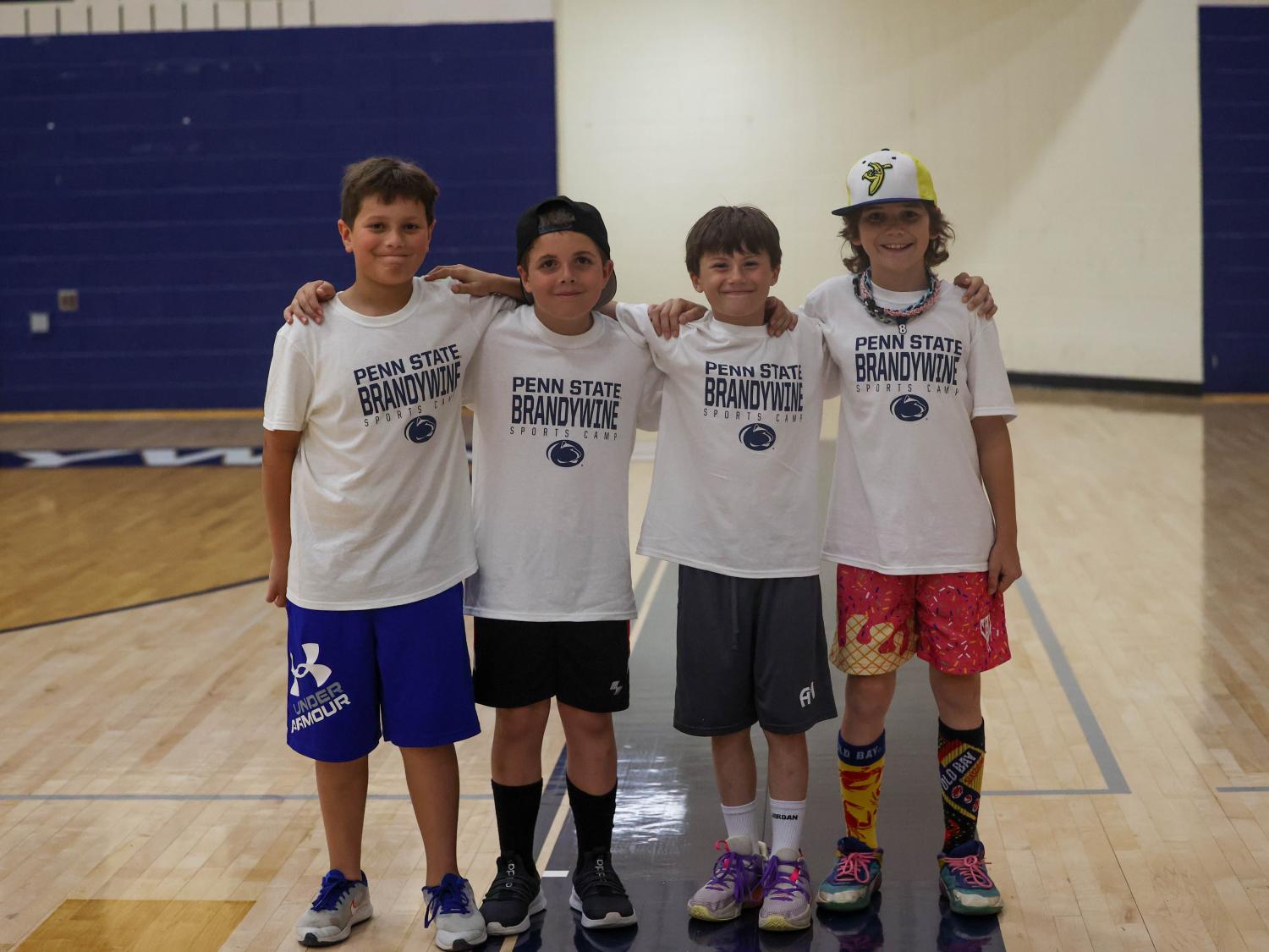 four kids at summer camp in the Brandywine gymnasium