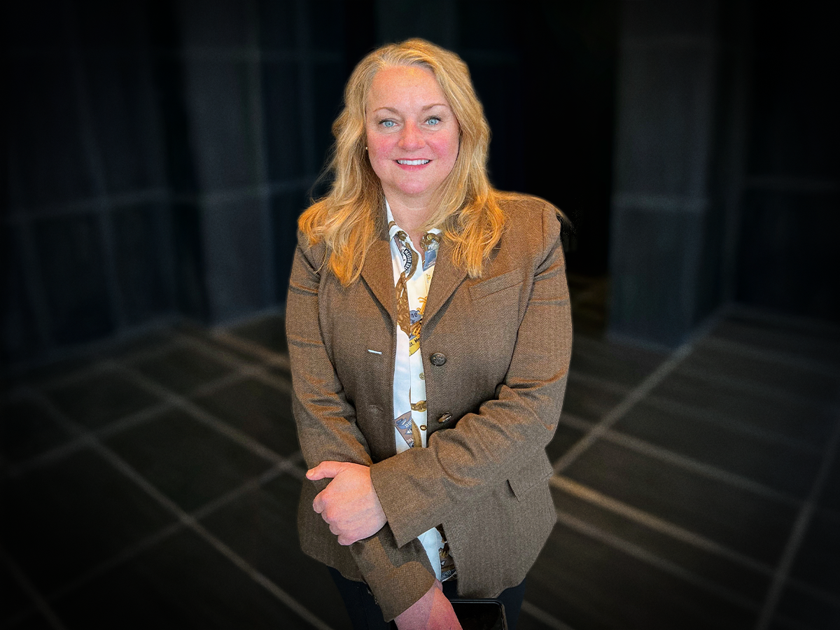 A photo of Jennifer Breese standing inside a lobby at PGH InfoSec Day.