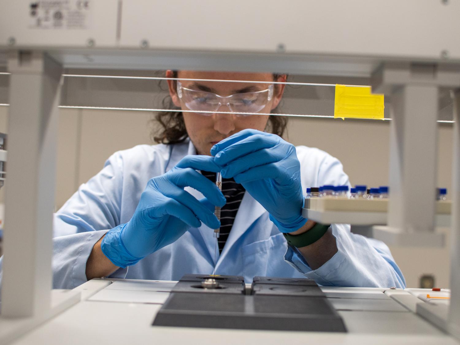 Researcher with a test tube working in a lab