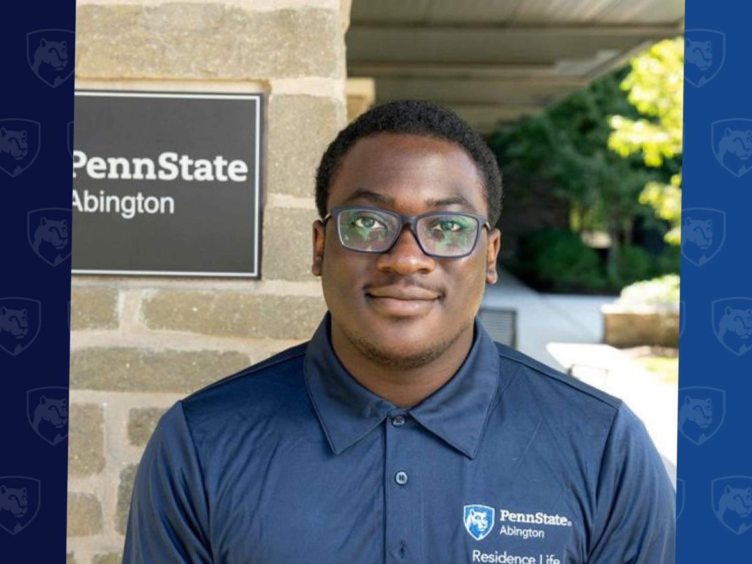 Laurence Orji with a Penn State Abington sign behind him