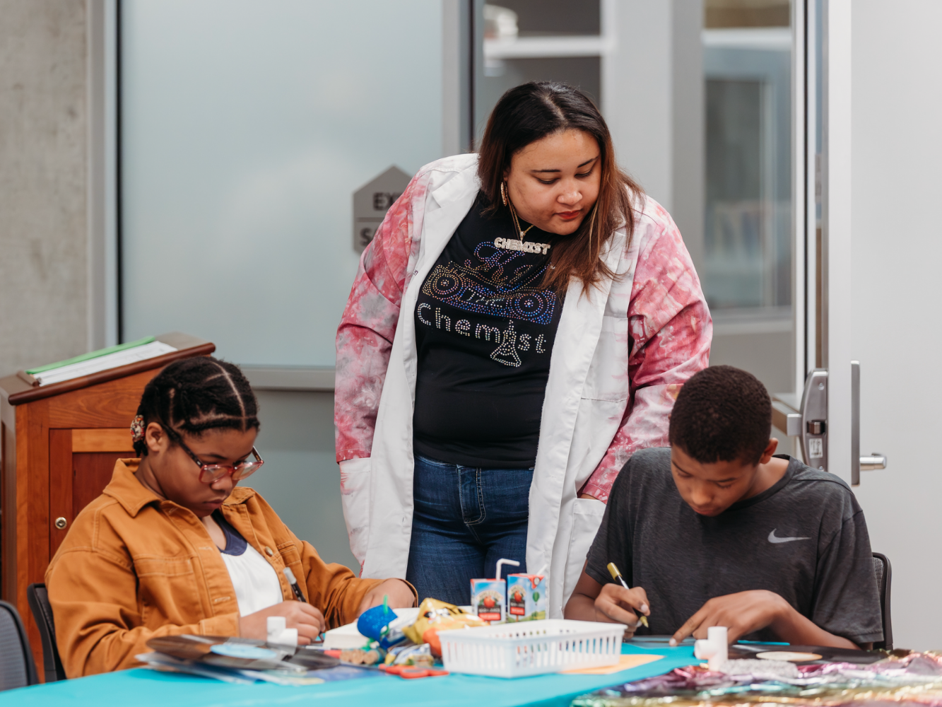 Simpson helps students during a workshop
