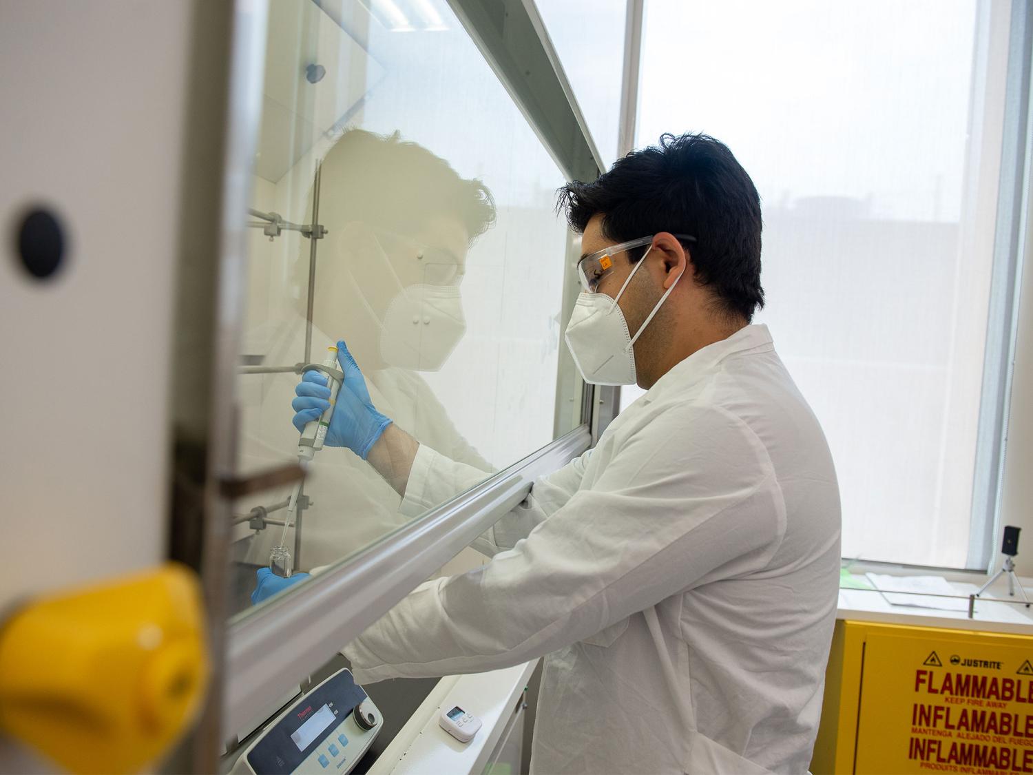 Amir Sheikhi, associate professor of chemical engineering at Penn State, in his lab testing his team's nanocellulose material in a large machine
