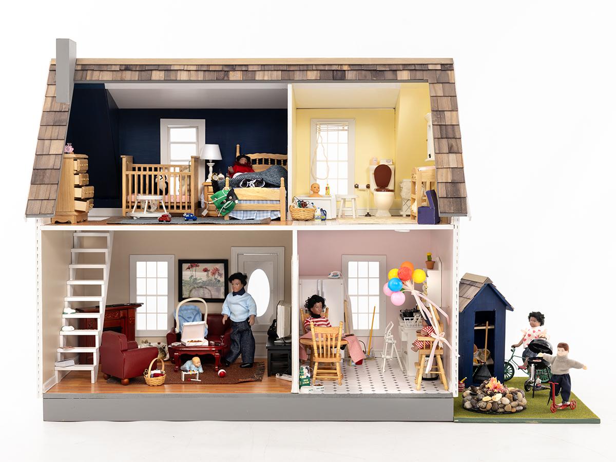 A dollhouse shows common household hazards in the bedroom, bathroom, living room, kitchen and backyard.