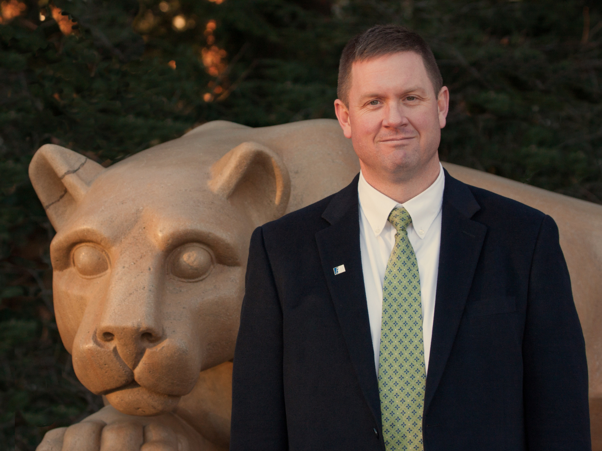 Daniel Perkins next to the Nittany Lion statue