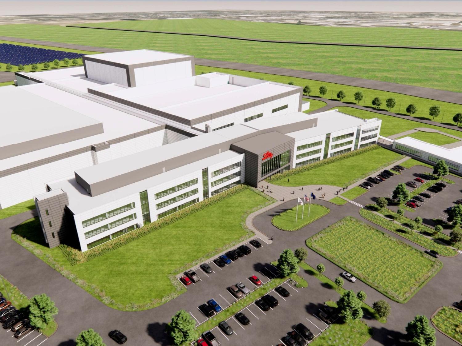 a large warehouse building surrounded by a parking lot and grassy areas