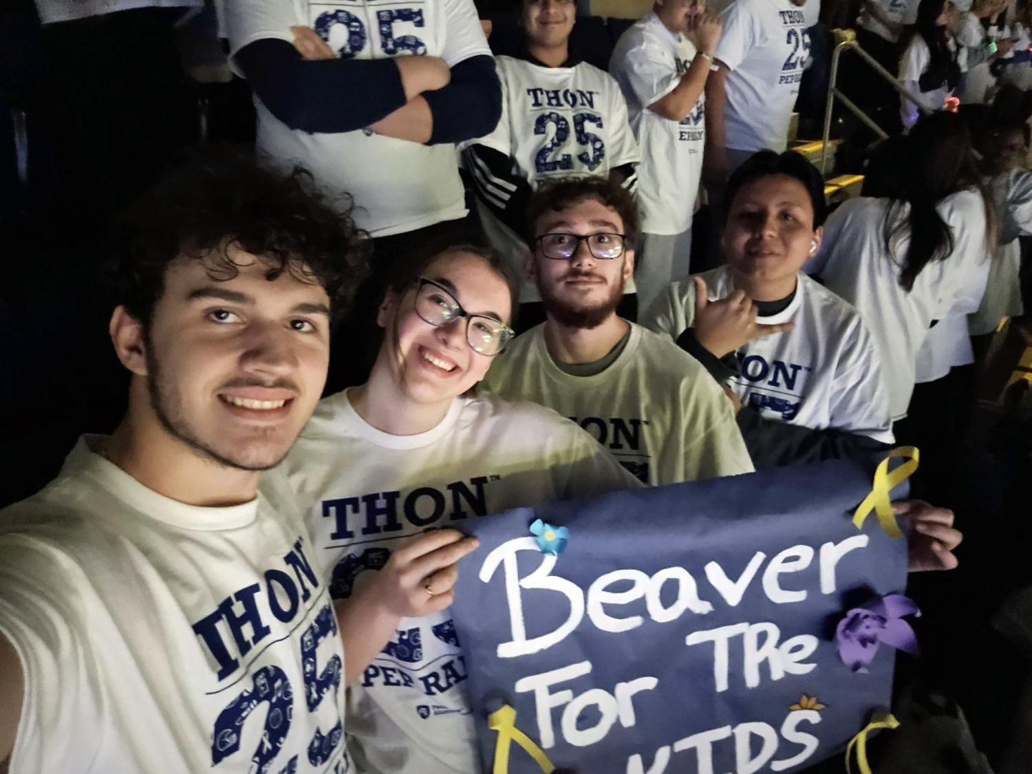 Four students hold a banner