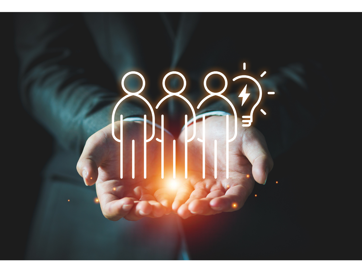 Hands hold up a group brainstorming graphic.