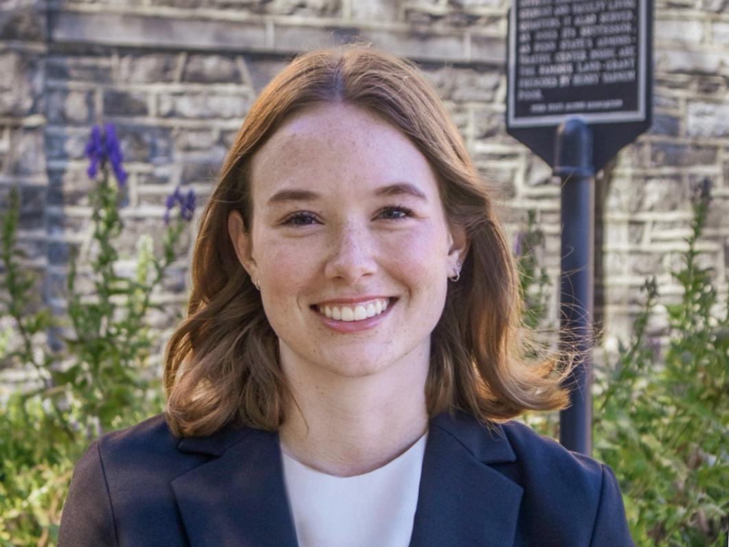 Avery Snowden stands outside Old Main at Penn State University Park.