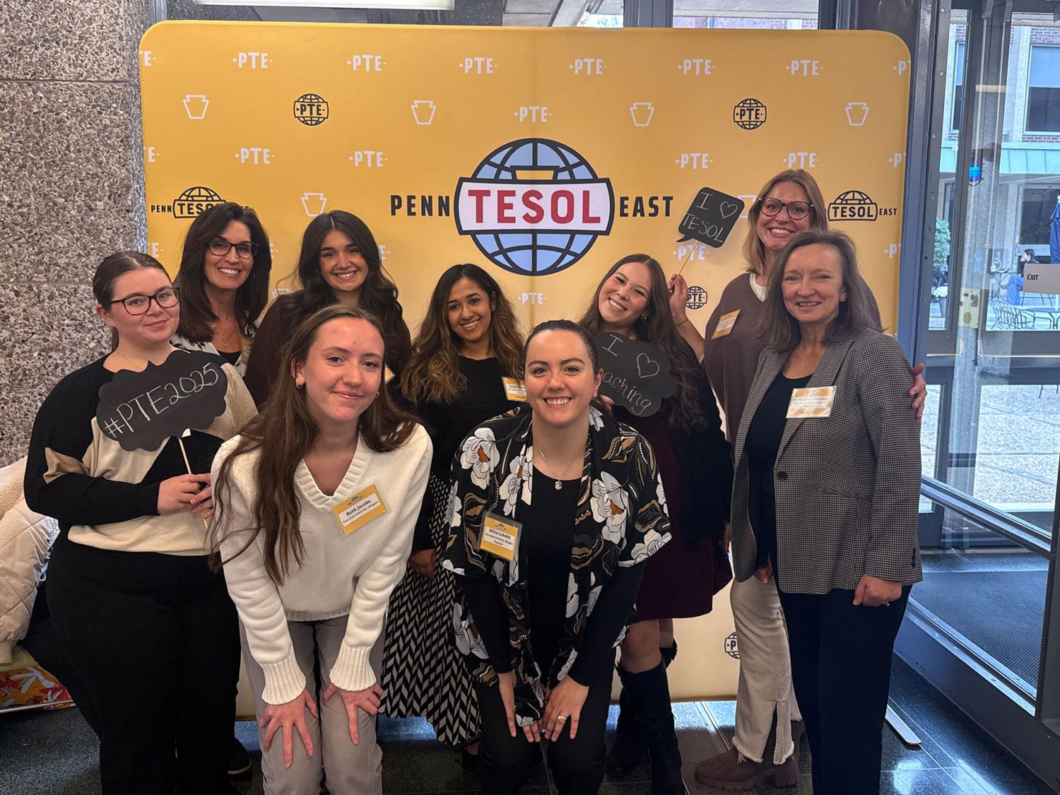 People standing in front of a banner