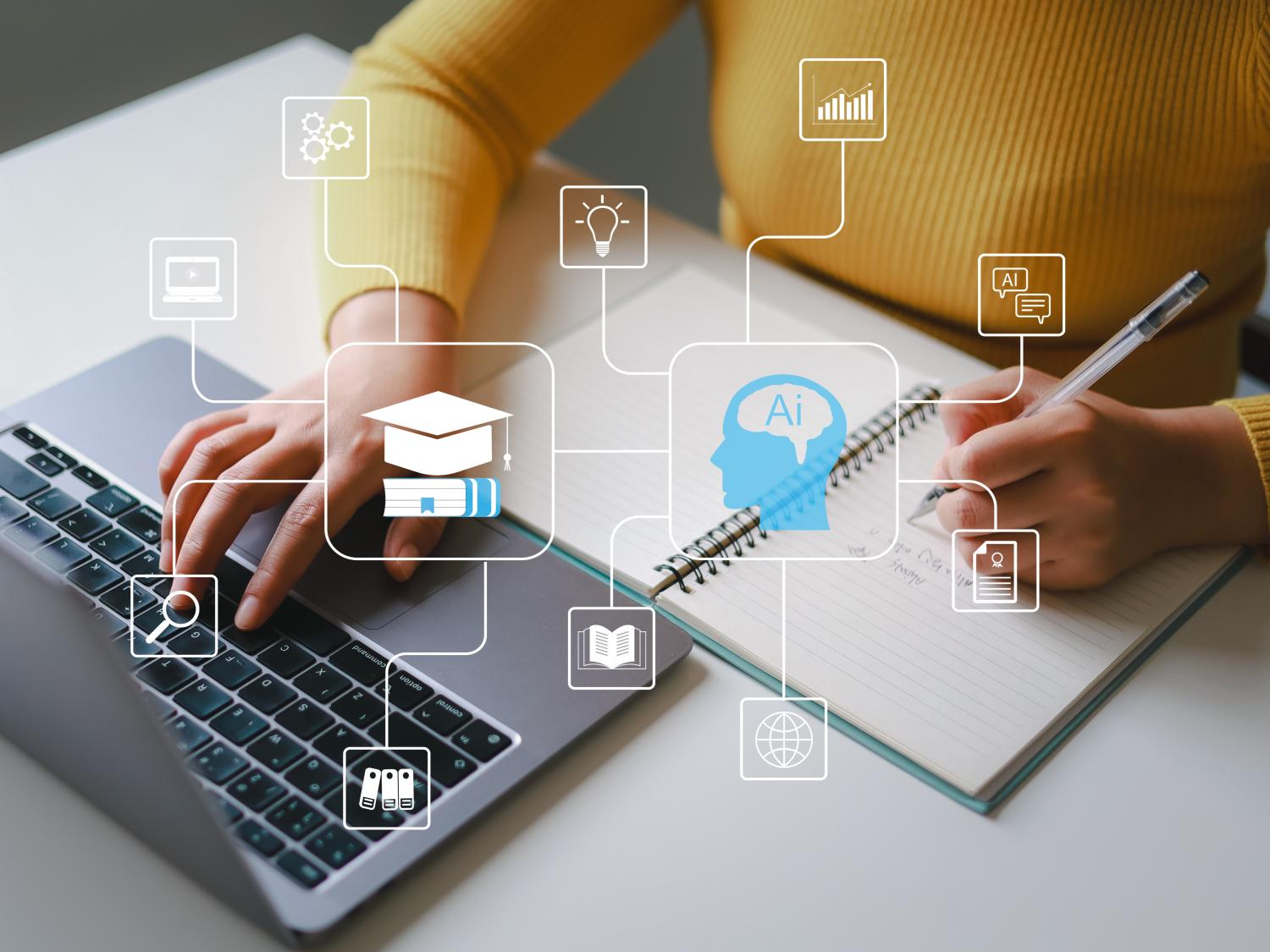 Closeup of a persons hands typing on a laptop and holding a pen