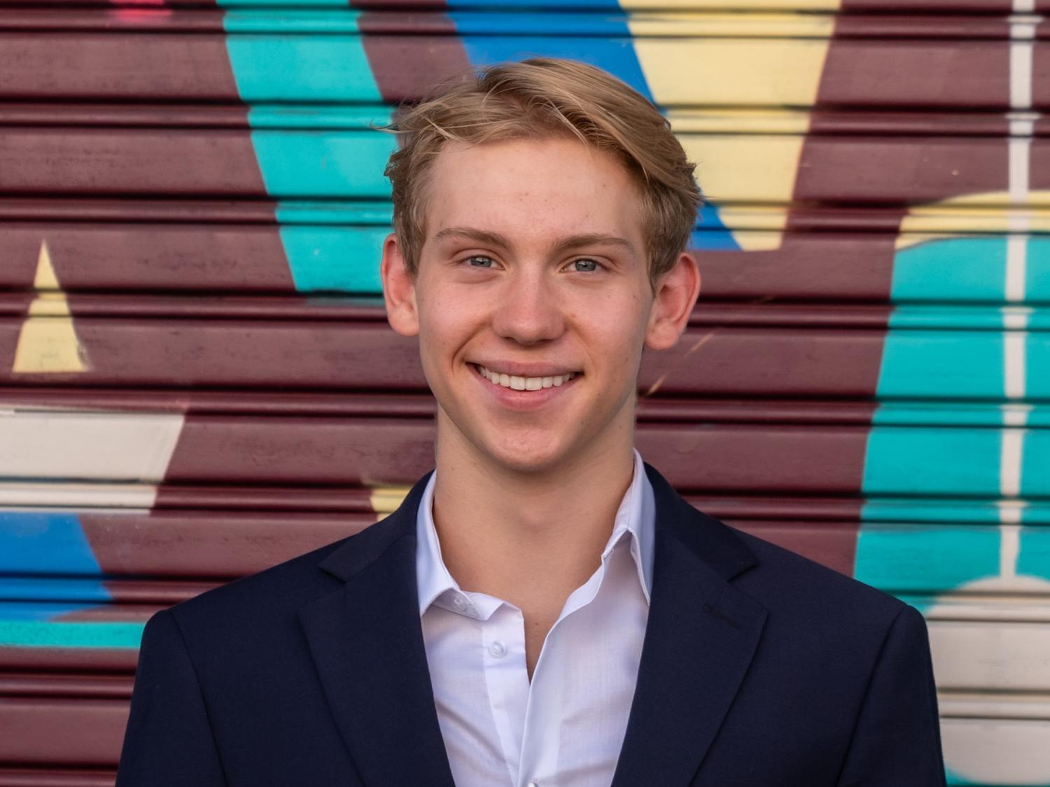 David Anderson posing in front of colorful metal background