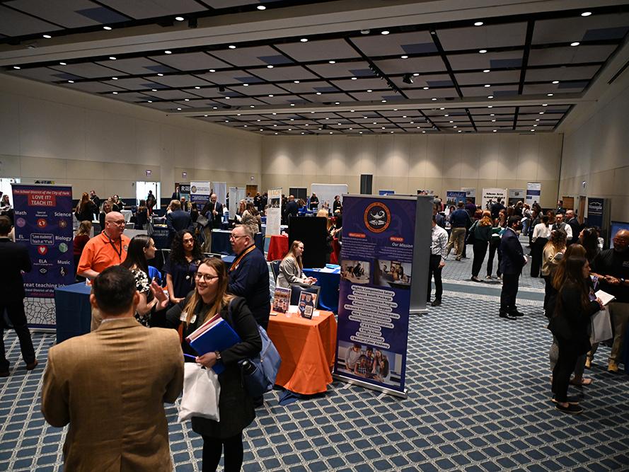 Education students meet with potential employers at a job fair.