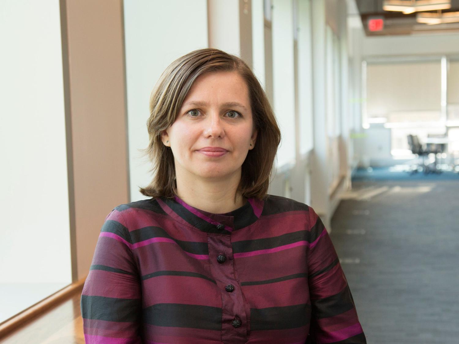 person with brown hair wearing striped top