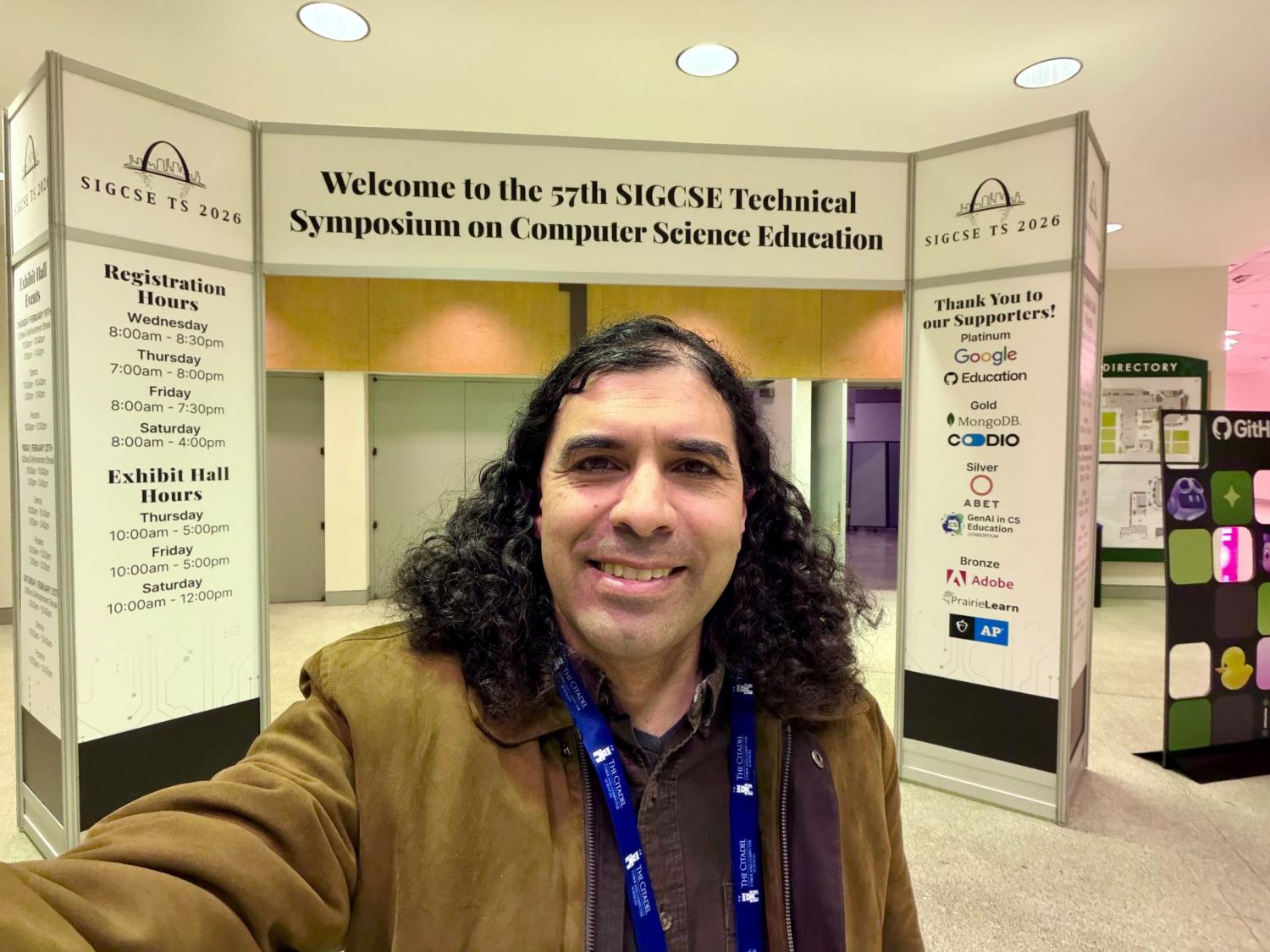 smiling person with long dark hair at computing conference