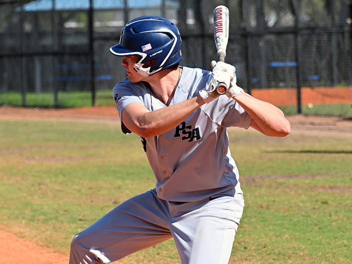 Oenn State Altoona baseball player Jonathan Rauch prepares to swing at the plate during a game, wearing a gray PSA uniform and batting helmet.