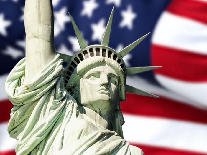 A collage of the Statue of LIberty atop a background depicting the American flag