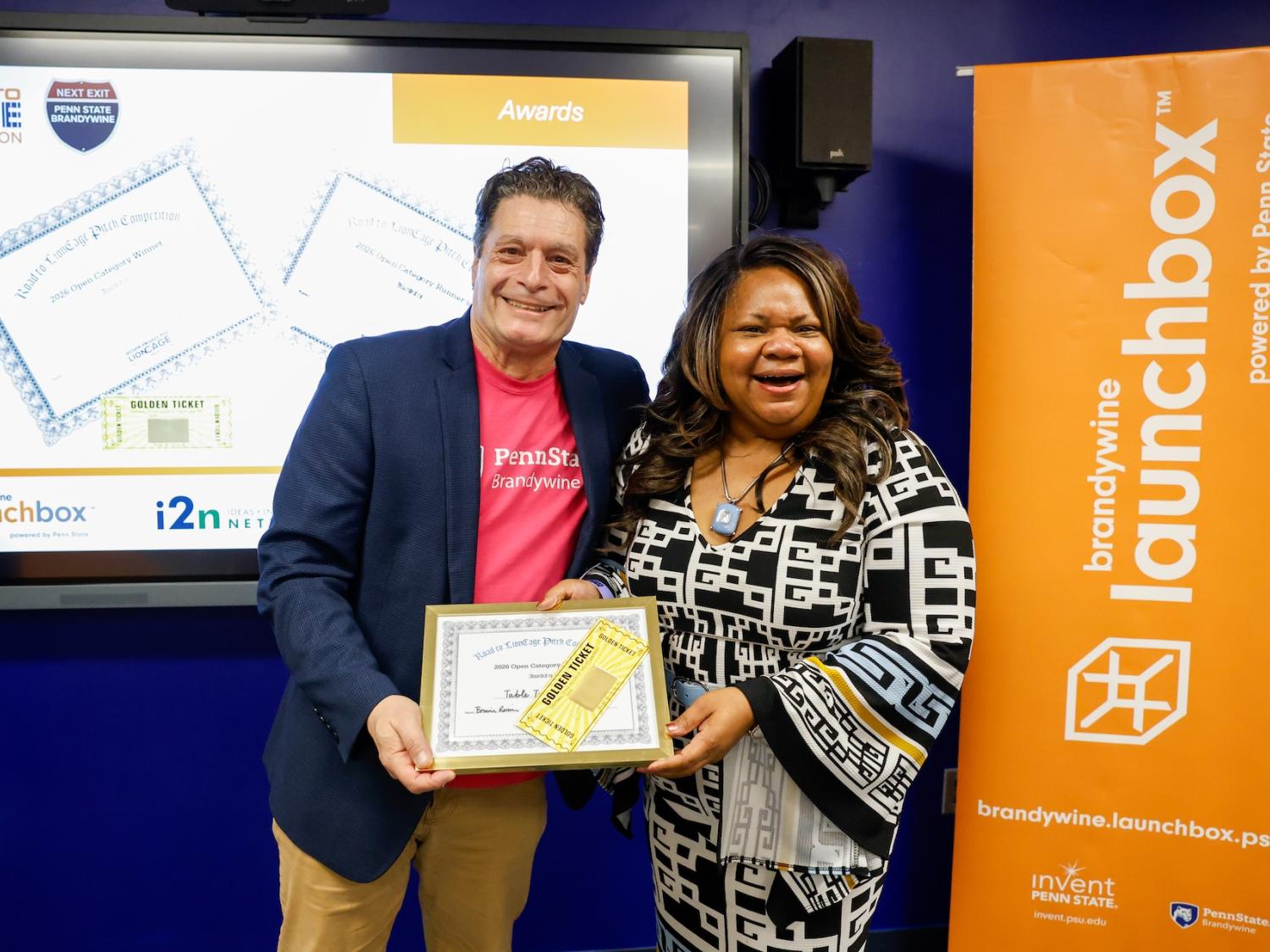 Tony Mattei and Nicole Rayfield holding winning certificate and golden ticket at Road to LionCage