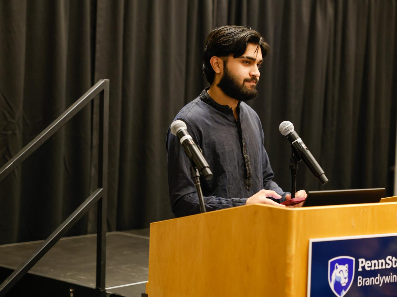 Shams Zia standing at a podium