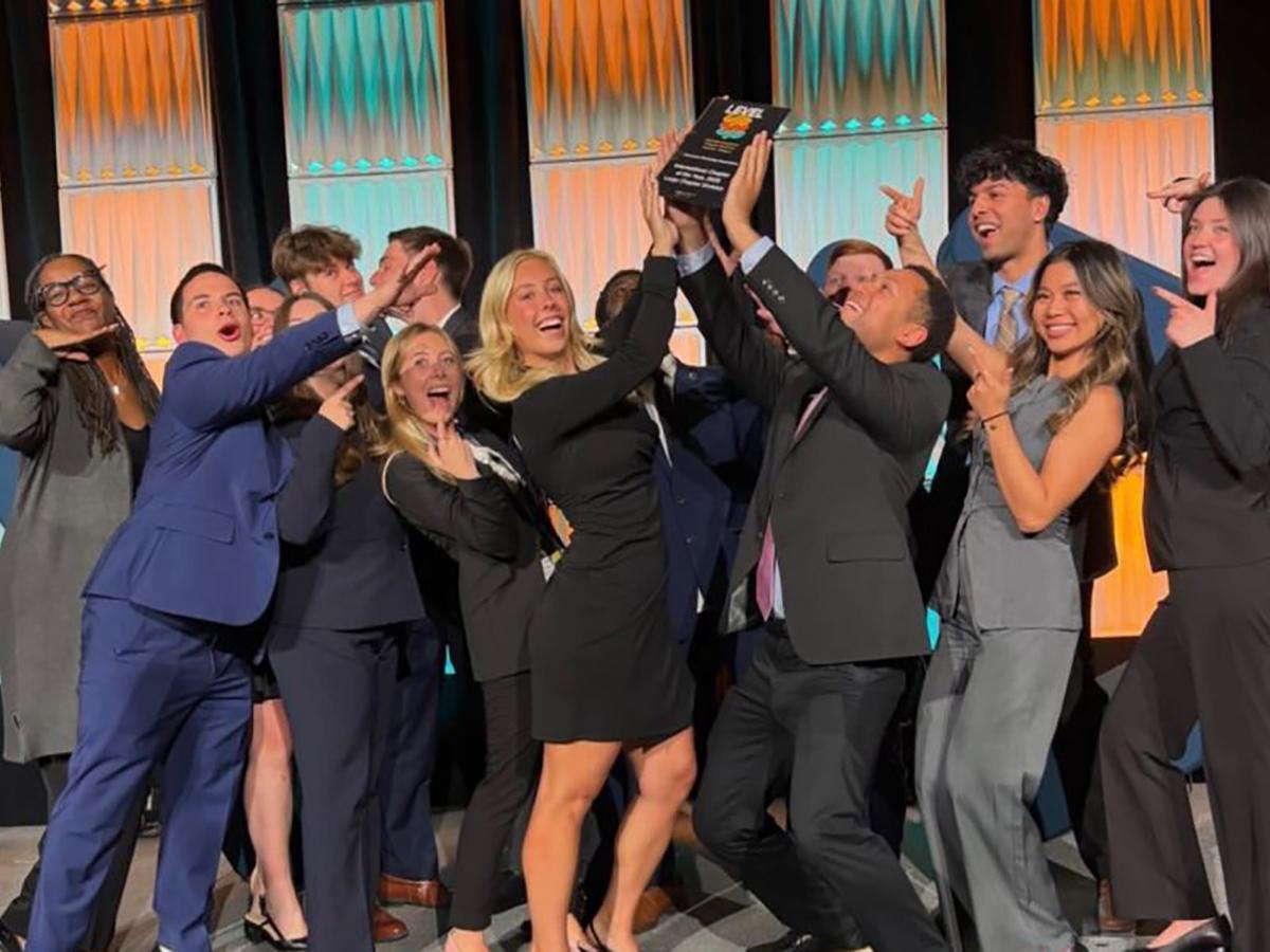male and female members of the Penn State Chapter of the AMA celebrate being named International Chapter of the Year