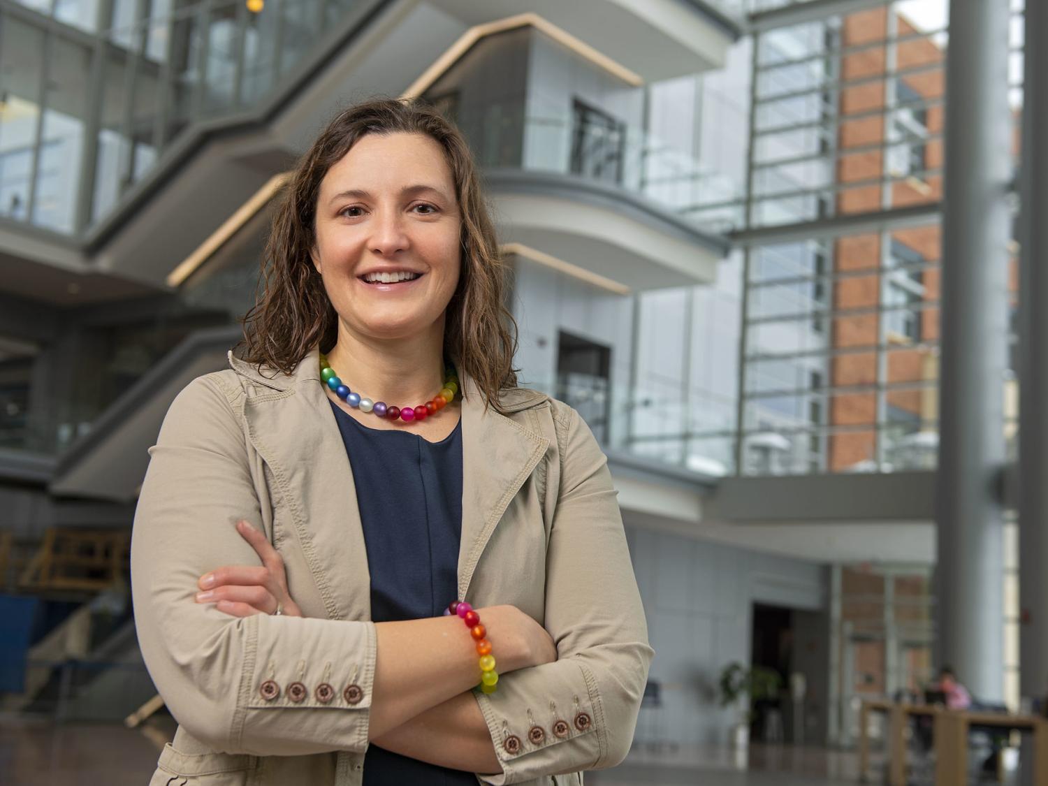 Karen Winterich stands in the Business Building atrium with the steps in the background.