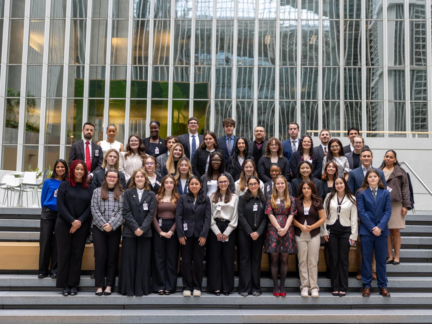 Students stand for a group photo in the atrium of the World Bank. 