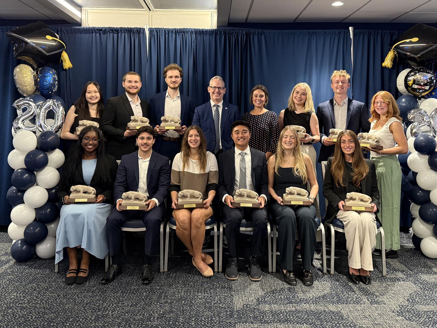 A photo of 12 students who won Smeal Senior Awards holding miniature Nittany Lion Shrines arrayed, sitting and standing, around John and Karen Arnold Dean Corey Phelps and Associate Dean for Undergraduate Education Jennifer EurySmeal’s Senior Award winners were recognized recently in a ceremony at the Bryce Jordan Center. Pictured above are, back row (left to right): Monica Wang, Palmer Moore, Jack McCormack, Dean Corey Phelps, Associate Dean for Undergraduate Education Jennifer Eury