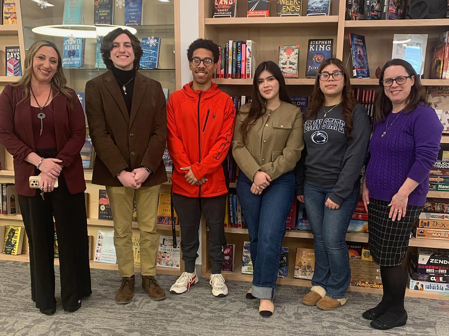 Student artists pose for a photo in the campus library