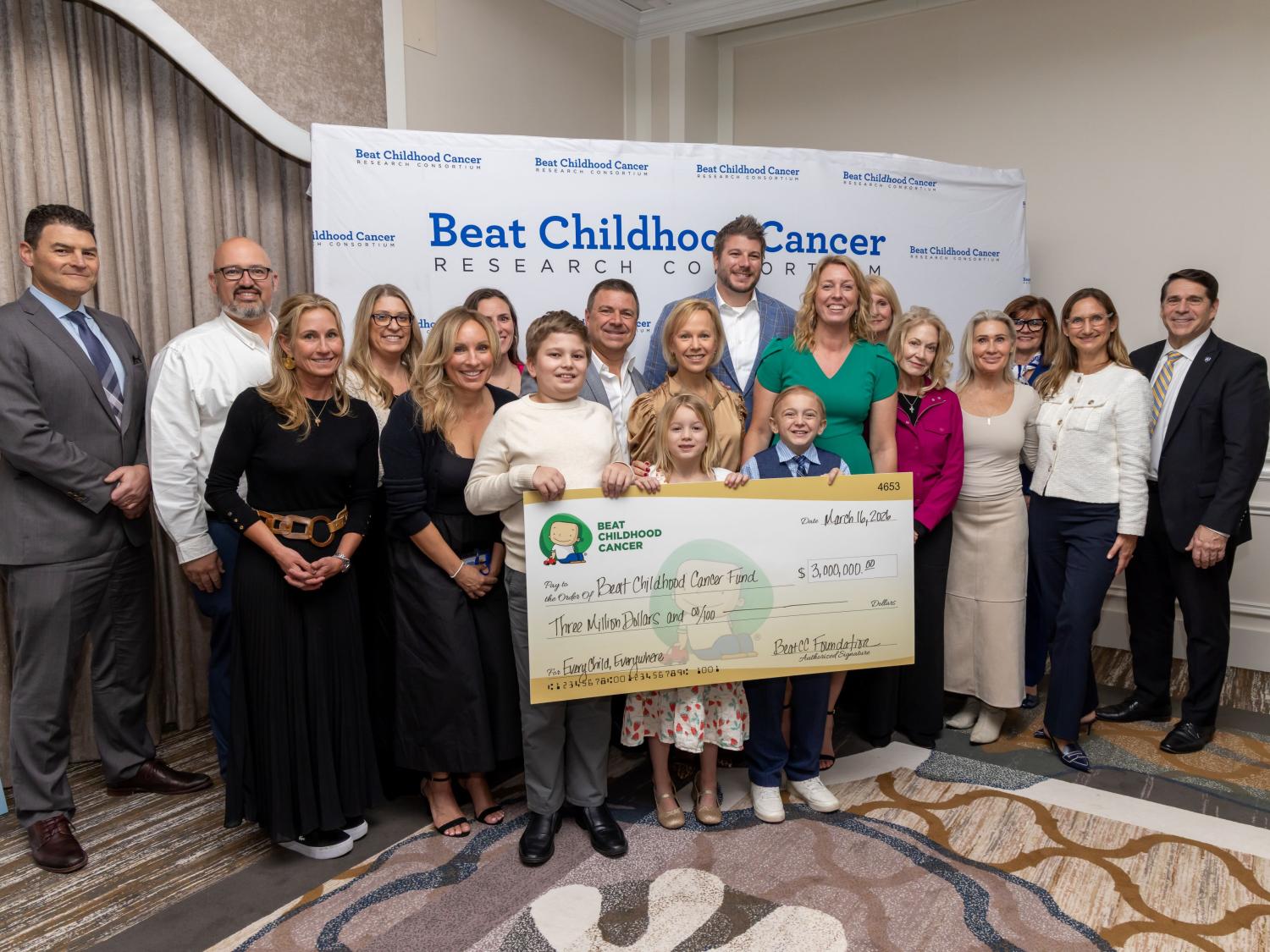 A group of researchers from the BCC Research Consortium and the BCC as well as some children accept a $3 million philanthropic donation with a giant check.