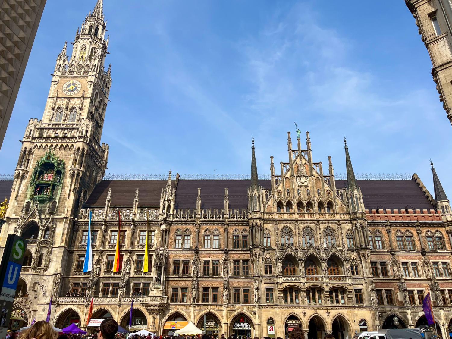 A Neo-Gothic, German town hall building on a sunny day.