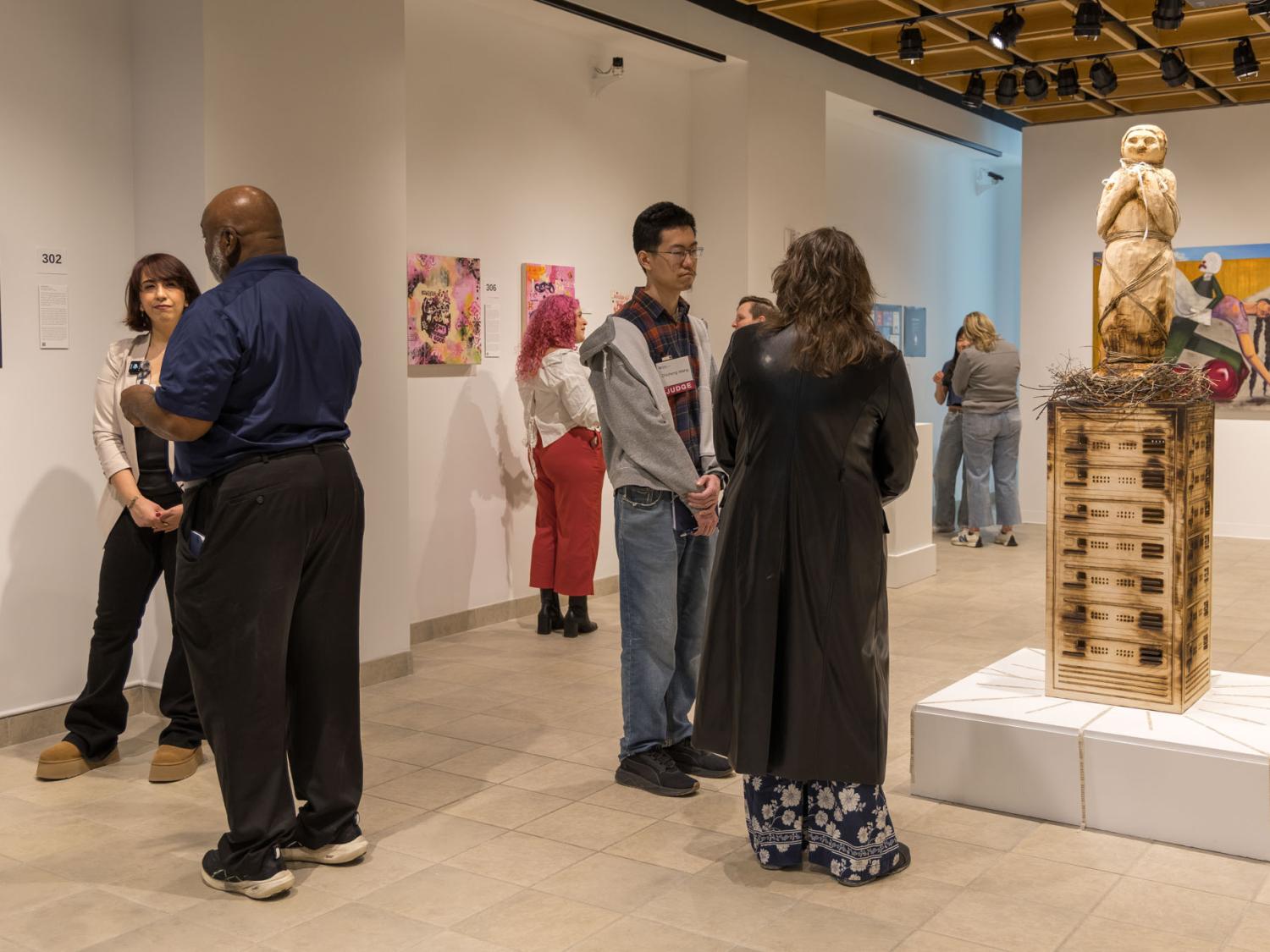 Gallery visitors talk with artists about their work