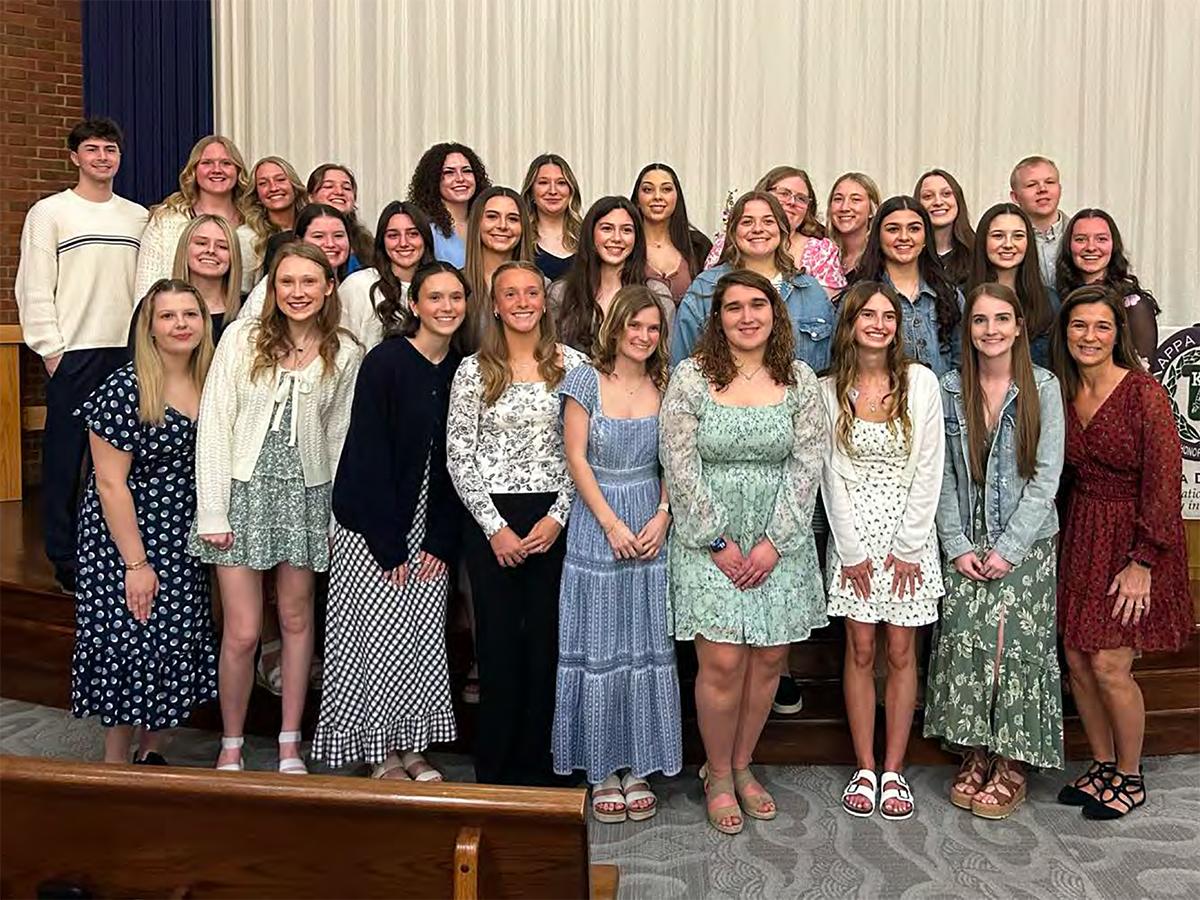 A group of students and faculty pose together for a photo during the spring 2026 induction ceremony of the Kappa Delta Pi national education honor society.