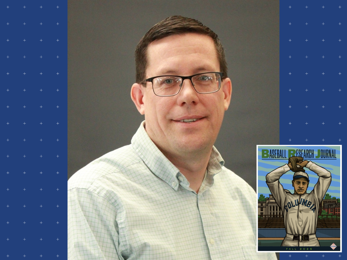photo of man with short straight brown hair wearing glasses and dress shirt, small inset cover illustration of baseball player