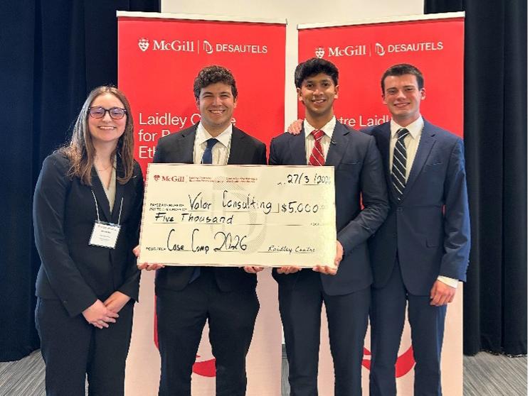 Four students, members of the Smeal Business Ethics Team, hold a check for $5,000 for winning the McGill case competition.