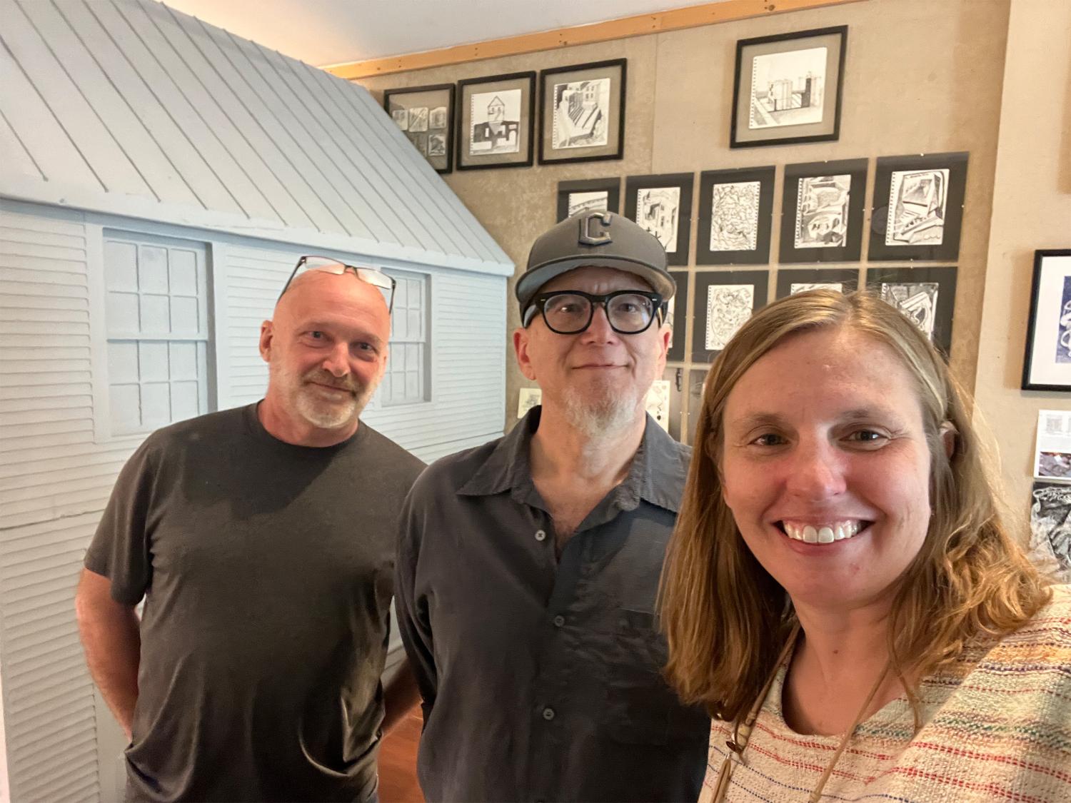 Ben Fehl, Joseph Cusumano and Sarah Zappe posing for a photo in front of various artworks