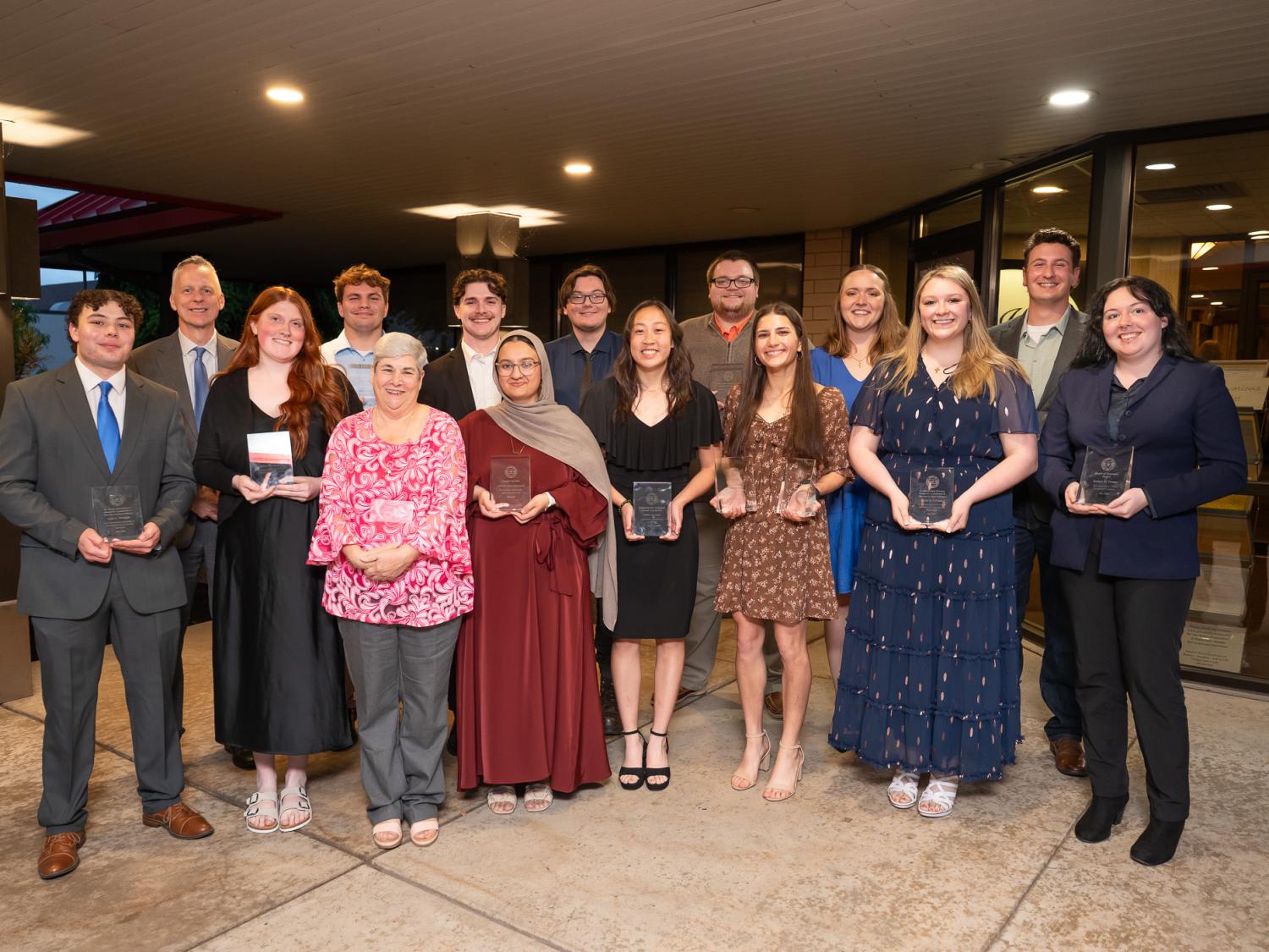 A large group of people pose for a group photograph