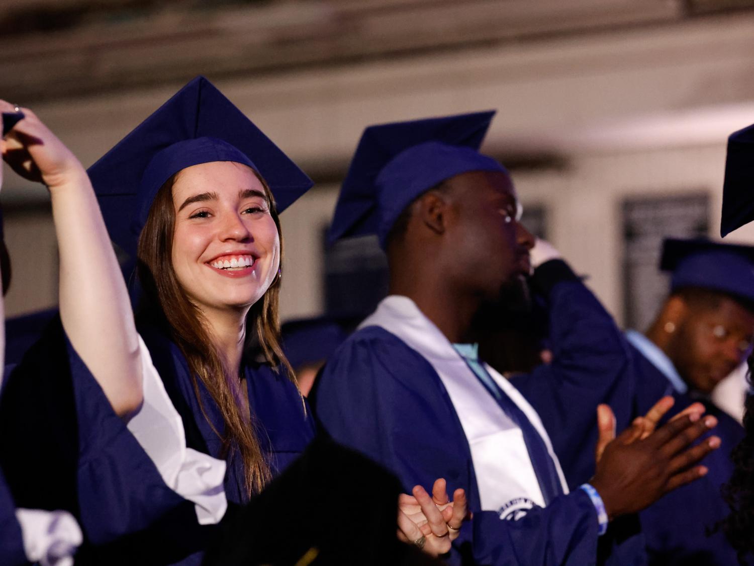 students clapping after moving tassel from right to left