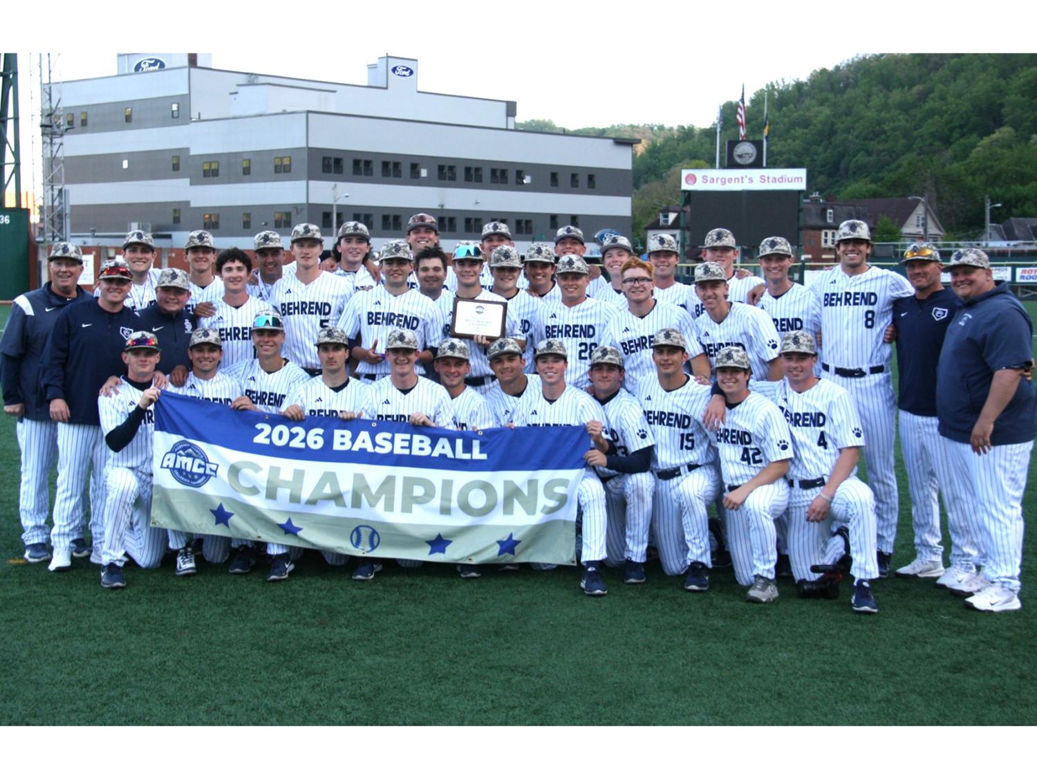 The Penn State Behrend baseball team poses with the AMCC championship banner.