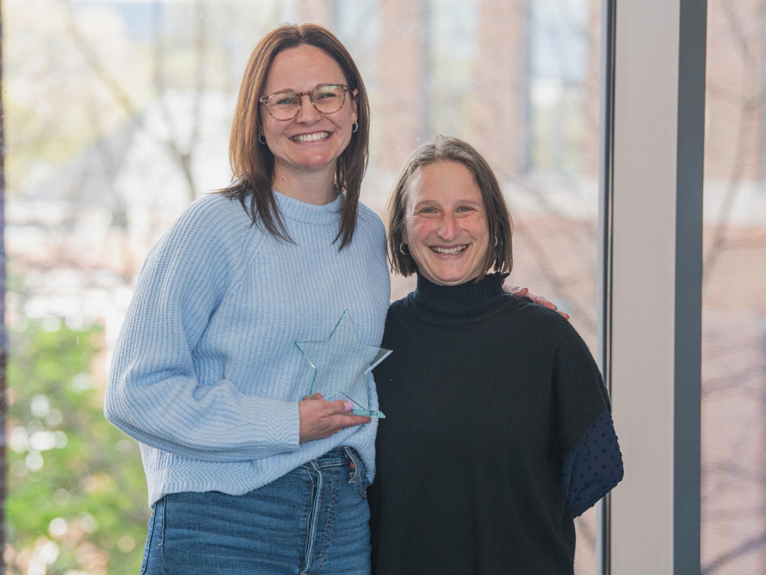 Janine Kwapis and Dean Tracy Langkilde posing with an award.