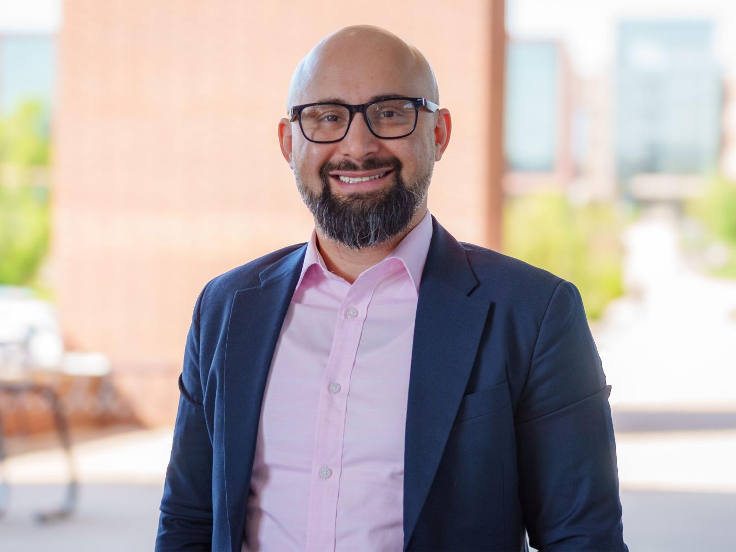 bald person with beard and glasses