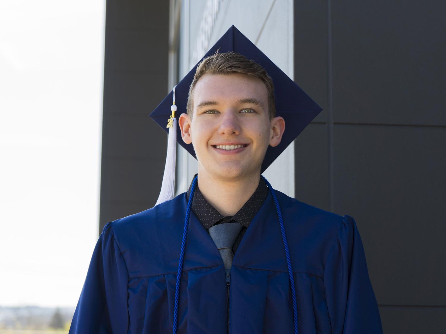 Male student wearing blue commencement regalia