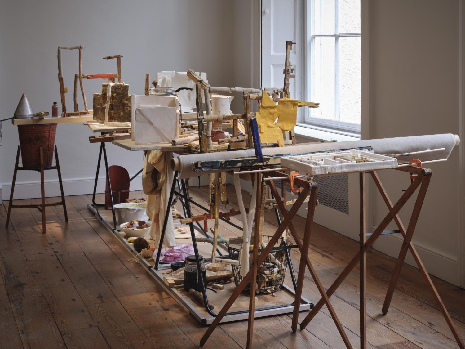 An art installation made with a collection of found materials such as wood, metal and fabric